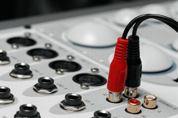 Rear panel of music system amplifier with wires