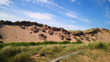 Footpath going through sand dunes at Balmedie Beach on a sunny day.