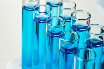 Laboratory test tubes with blue liquid close up