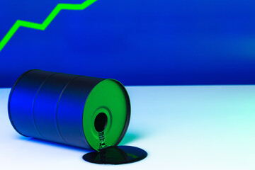 Price of american oil is changing concept. Black barrel with oil and graph