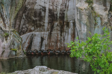Lake, boats and rocks. China, Shaoxing, East lake