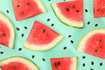 Composition with fresh watermelon slices on mint background, top view