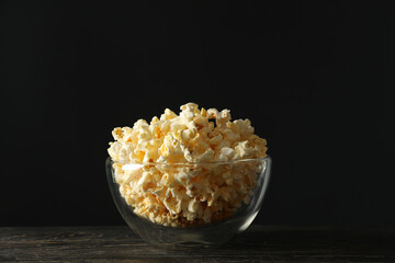 Bowl with popcorn on wooden table. Food for watching cinema