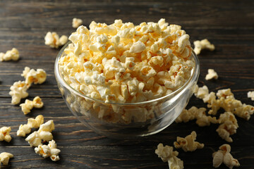 Bowl with popcorn on wooden table. Food for watching cinema