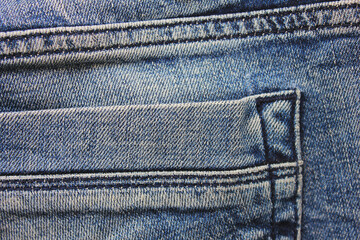 Denim blue jeans pocket details. Casual clothing texture, old jeans blue fabric details with seams...