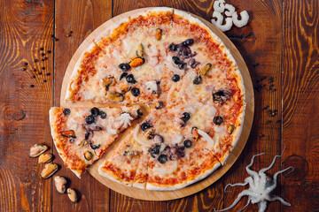 seafood pizza on wooden table in a restaurant