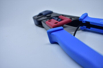 reliable tool for crimping connectors and twisted pair RJ-45 on white background