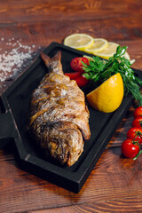 fried fish on the table in a restaurant, breaded dorado