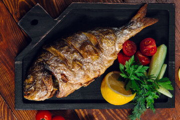 fried fish on the table in a restaurant, breaded dorado