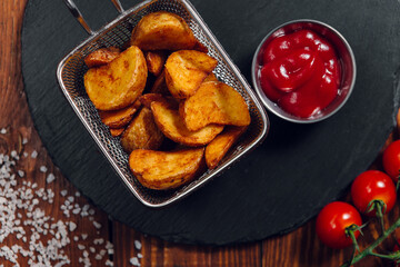 French fries and tomatoes on a table in a restaurant. Fast food, junk food