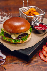 Burger with fries and ketchup on a table in a restaurant. Fast food, junk food