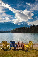 Multi-colored adirondack lawn chairs on the lawn in front of Jasper Lake Lodge, Jasper, Alberta, Canada.