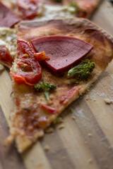 pizza with ham tomato cheese and broccoli