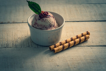 Scoops of ice cream on wooden background