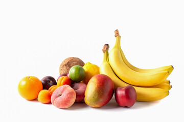 Obraz na płótnie Canvas Tropical fruits assortment isolated on white background. Coconut, bananas, mango, orange, lime, lemon, peaches, apricots and plums.