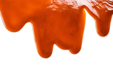 Background of flowing caramel sauce isolated on white.