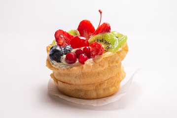 Home made cake with cream and fruits isolated.