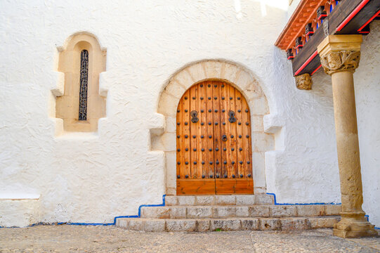 Old entrance door of an ancient building with a graceful pattern in Sitges, Spain