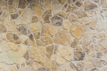 Concrete wall interspersed with many decorative stones. Great for background	