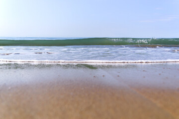 waves with foam on tropical sandy beach. copy space