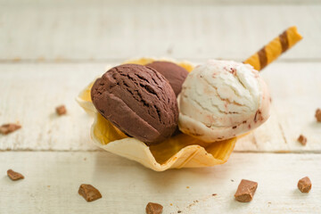 Scoops of ice cream on wooden background
