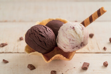 Scoops of ice cream on wooden background