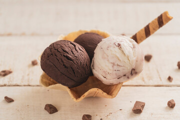 Scoops of ice cream on wooden background