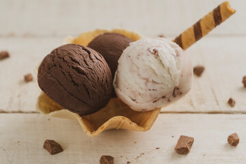 Scoops of ice cream on wooden background