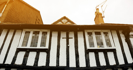 Wall and building typical Tudor English style, old windows frame and chimney on the roof in Stratford  Upon Avon, England, UK