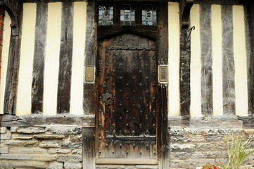 Wall and building with wooden door in the middle, typical Tudor English style in Stratford  Upon Avon, England, UK