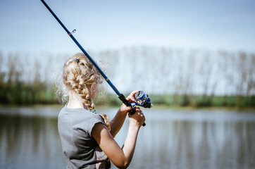 cute girl holding a fishing rod