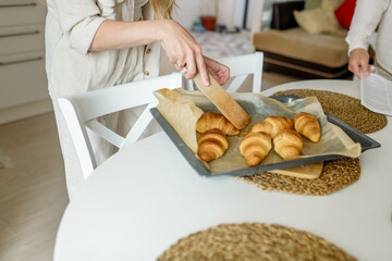 Woman's hands with a tray of homemade baked goods
