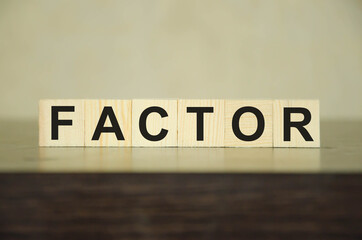  text factor written on wooden cubes. risk factors. evaluation of sales factors