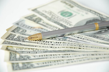  the pen lies on a white background and money. tuition fee. financing