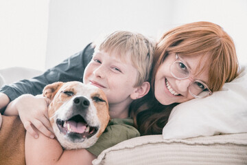 Woman, Child and Dog in a Bed and Smiling