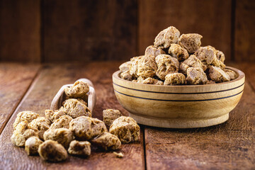 Granulated PINK SOY PROTEIN. used in vegan foods as a meat substitute. Food supplement.