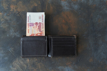 Russian rubles. Five thousandth notes stick out of the wallet. High quality photo