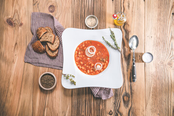 Bean soup in bowl on wooden table. Delicious lunch