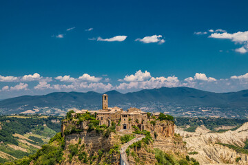View of the medieval town of Civita di Bagnoregio, located on the top of a spur of tuff rock, in...