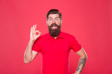 Best haircut here. Promoting barber services. Portrait of bearded man red background. Brutal guy...