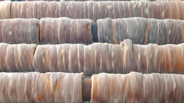 Closeup of traditional Czech sweet bakery Trdelnik (Trdlo) cooking on the Prague Street background.