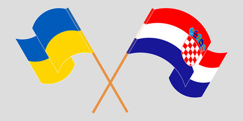 Crossed and waving flags of the Ukraine and Croatia