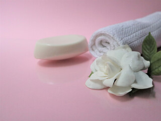 Fototapeta na wymiar Spa setting and Spa background composition with white gardenia flower on pink background.