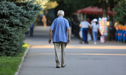 old man walking in summer park