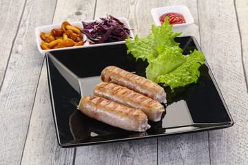 Grilled sausages served mushrooms and cabbage