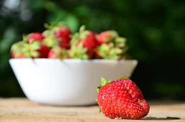resh strawberries in bowl natural background