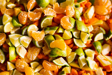 Pile of fruit. Tangerines, lemmon, carrots.