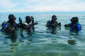 A group of scuba divers training in the lake.
