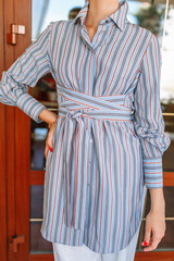 A girl in light blue summer clothes with a Japanese belt