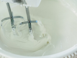 beat the cream for the cake with a mixer. poster.